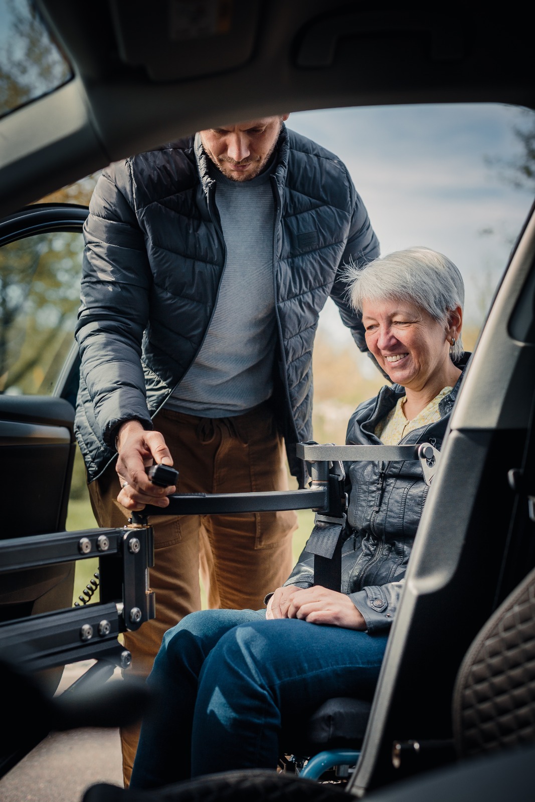 elderly person smiling while using a mobility aid with caregiver, warm lighting, professional photography