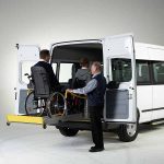 AMF Bruns solid linearlift lifting wheelchair and user into the rear of a Ford Transit