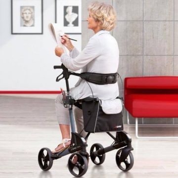 Woman sitting on Troja using rear backrest accessory.