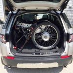 Trekinetic GTE folds up and stores into rear of suv (2017 Land Rover Discovery). Wheels can be attached or detached.